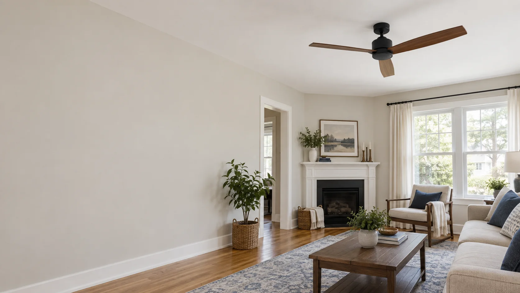 Illustrative view of a stationary wood-blade ceiling fan above a comfortable living room